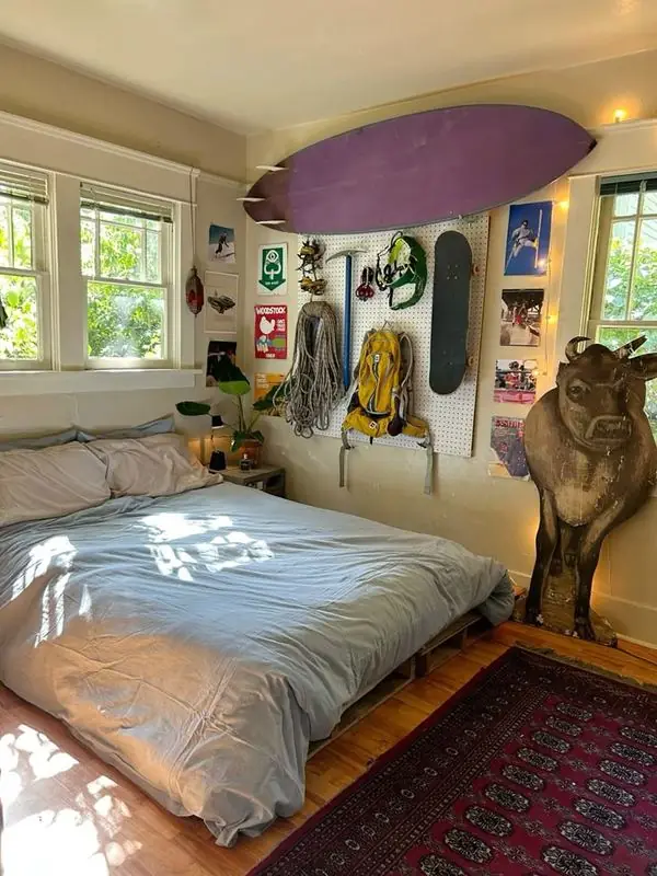 Bedroom with surfboards and outdoor gear on the wall
