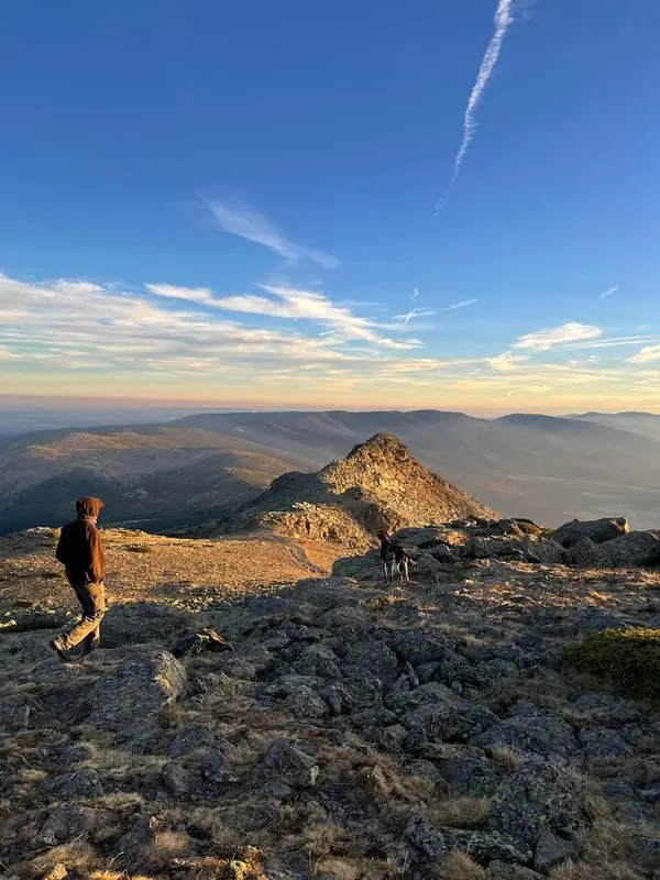 Walking across a rocky ridge at sunrise